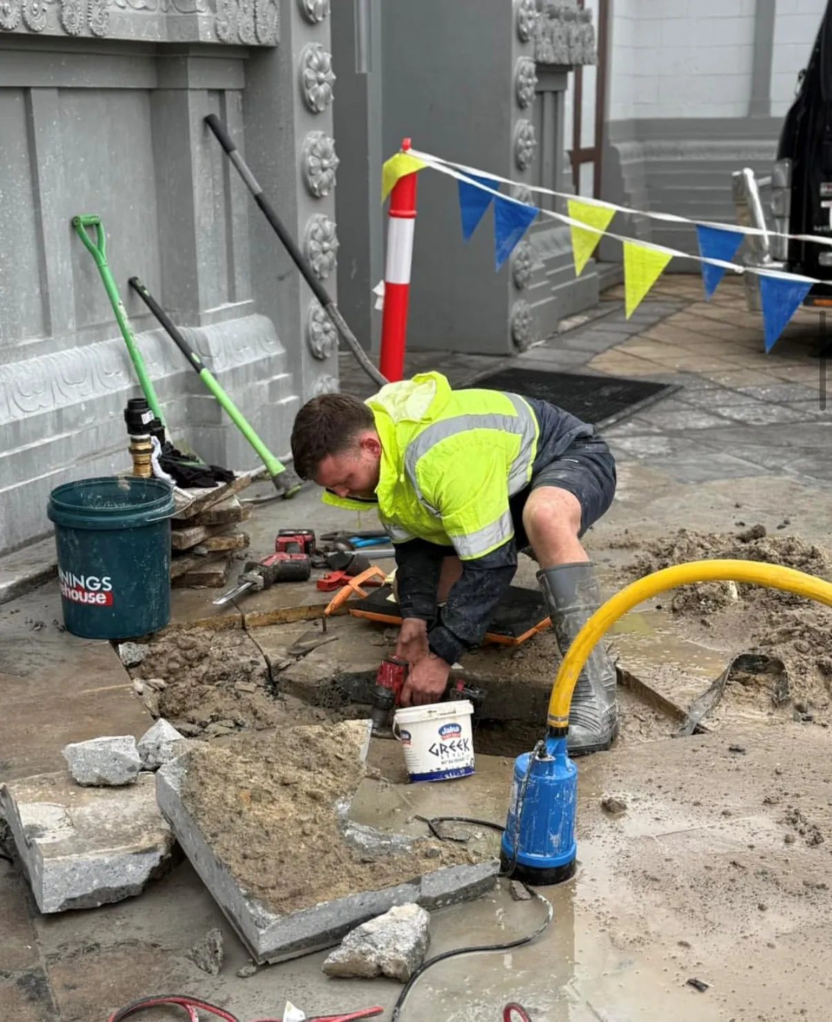 Footpath excavation around live services with barricading and dewatering