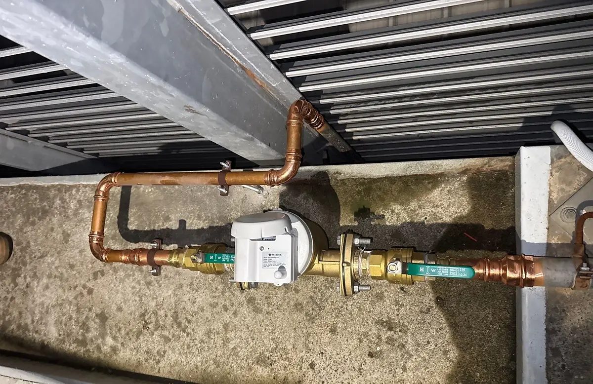 Water meter with IoT data logger on a copper service